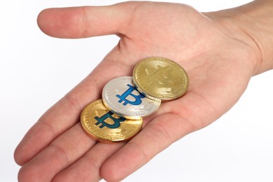 Photo of Cryptocurrency. Man holding different bitcoins on white background, closeup