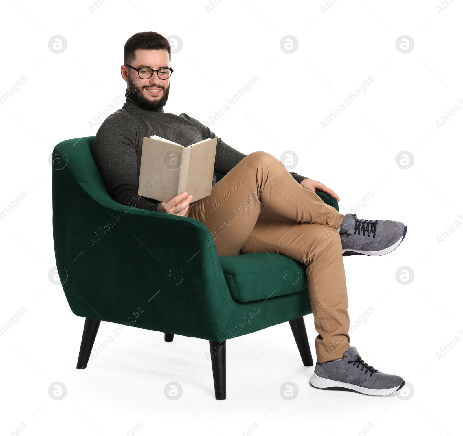 Smiling man with book relaxing on armchair against white background Photo of Smiling man with book relaxing on armchair against white background