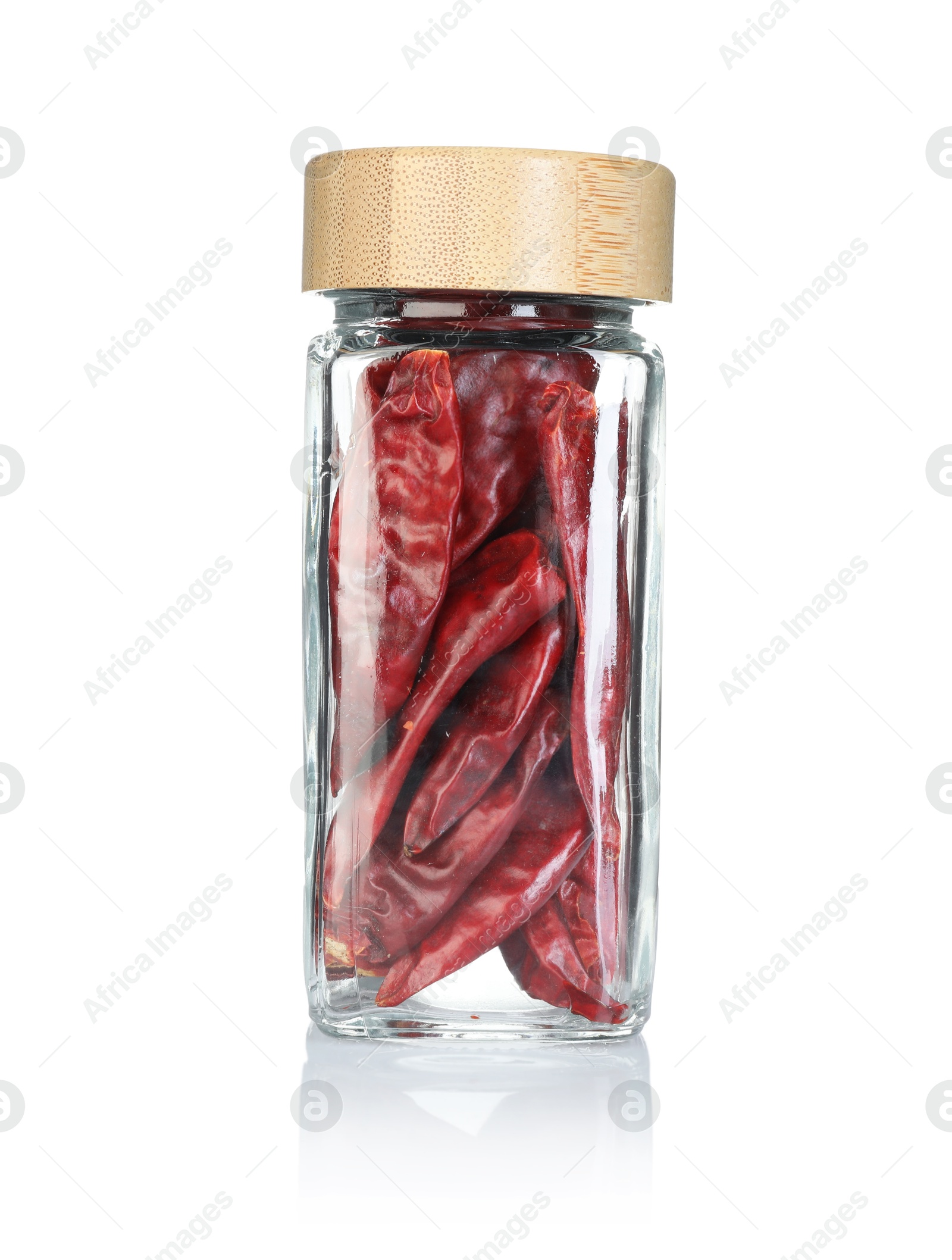 Red chili peppers in spice jar isolated on white Photo of Red chili peppers in spice jar isolated on white