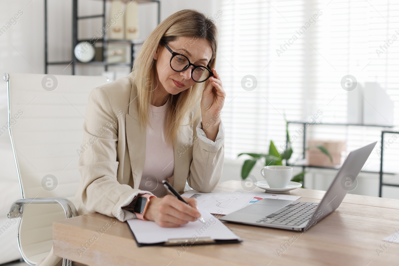 Professional banker working at desk in office Photo of Professional banker working at desk in office