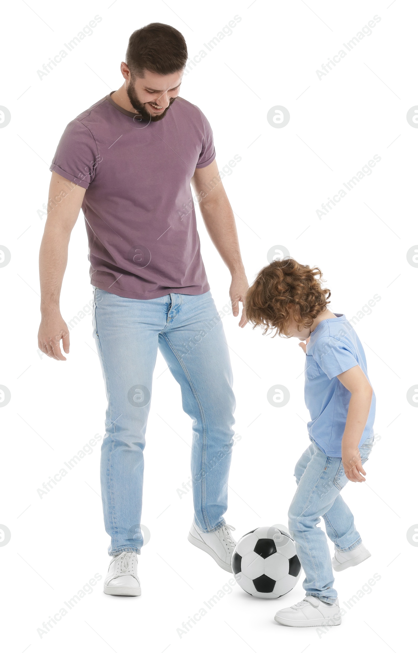 Happy father and his son playing football on white background Photo of Happy father and his son playing football on white background
