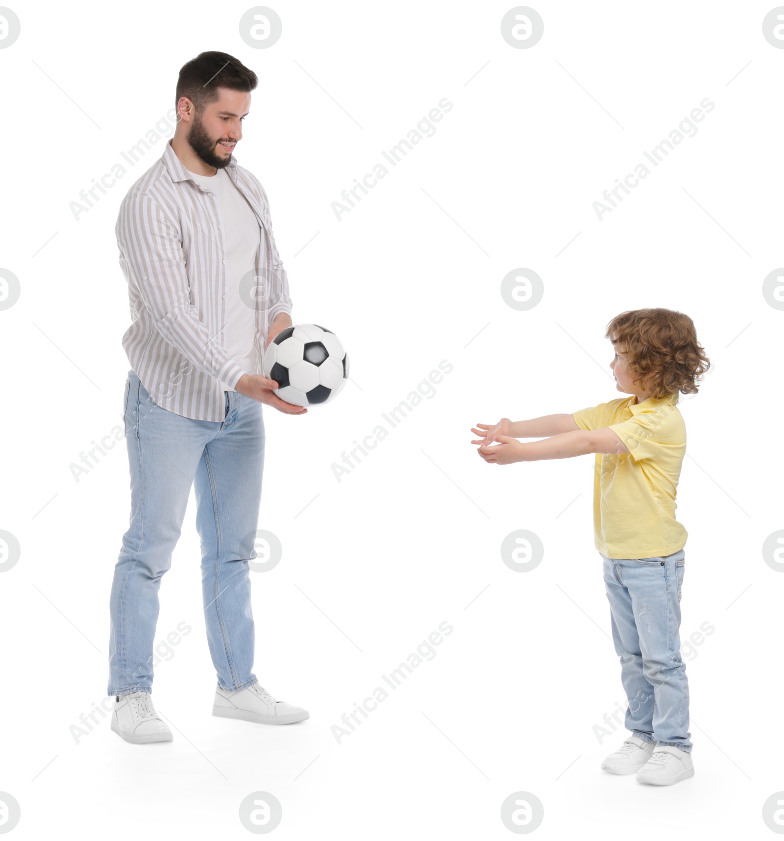 Happy father and his son playing football on white background Photo of Happy father and his son playing football on white background