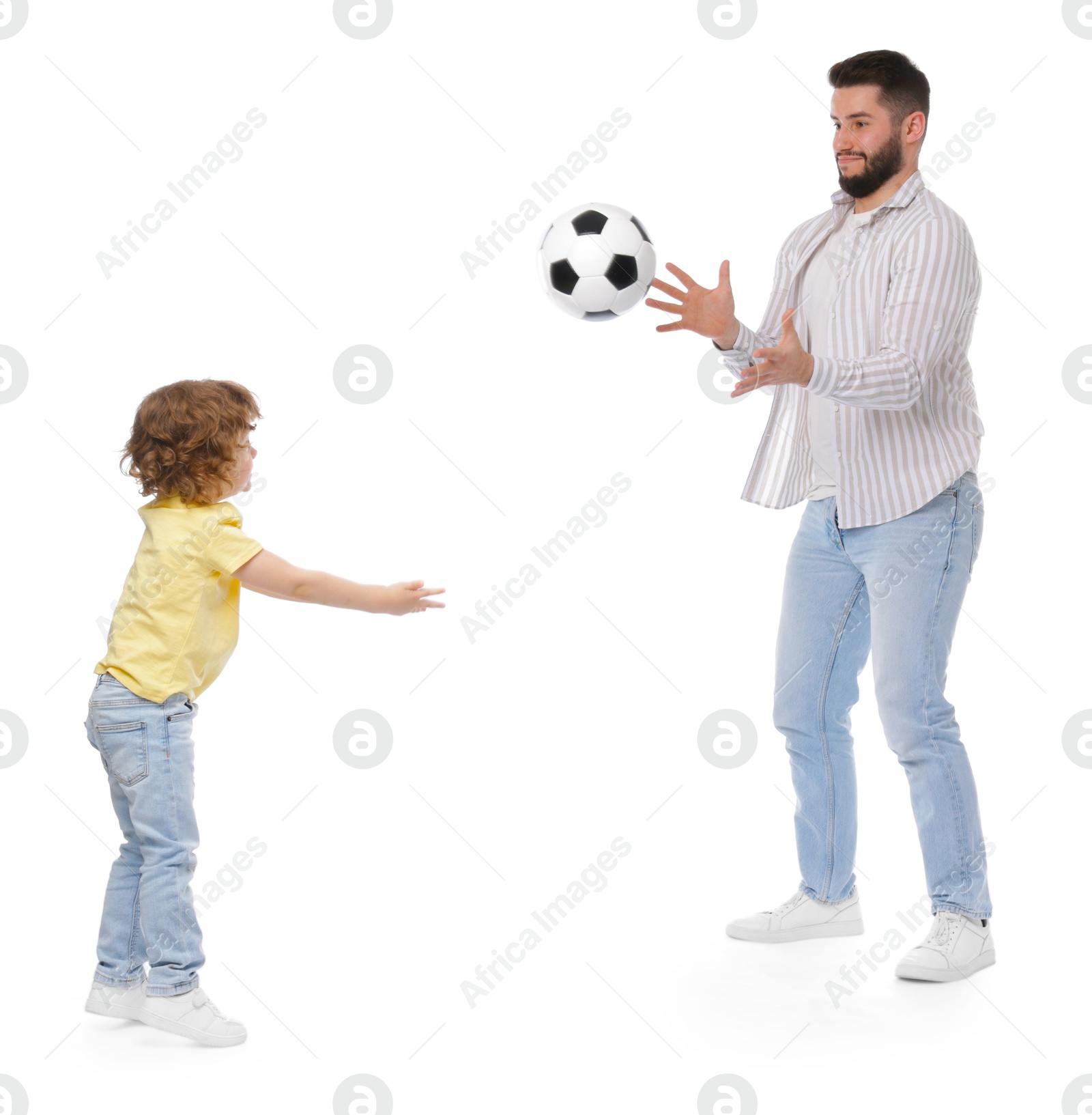 Happy father and his son playing football on white background Photo of Happy father and his son playing football on white background