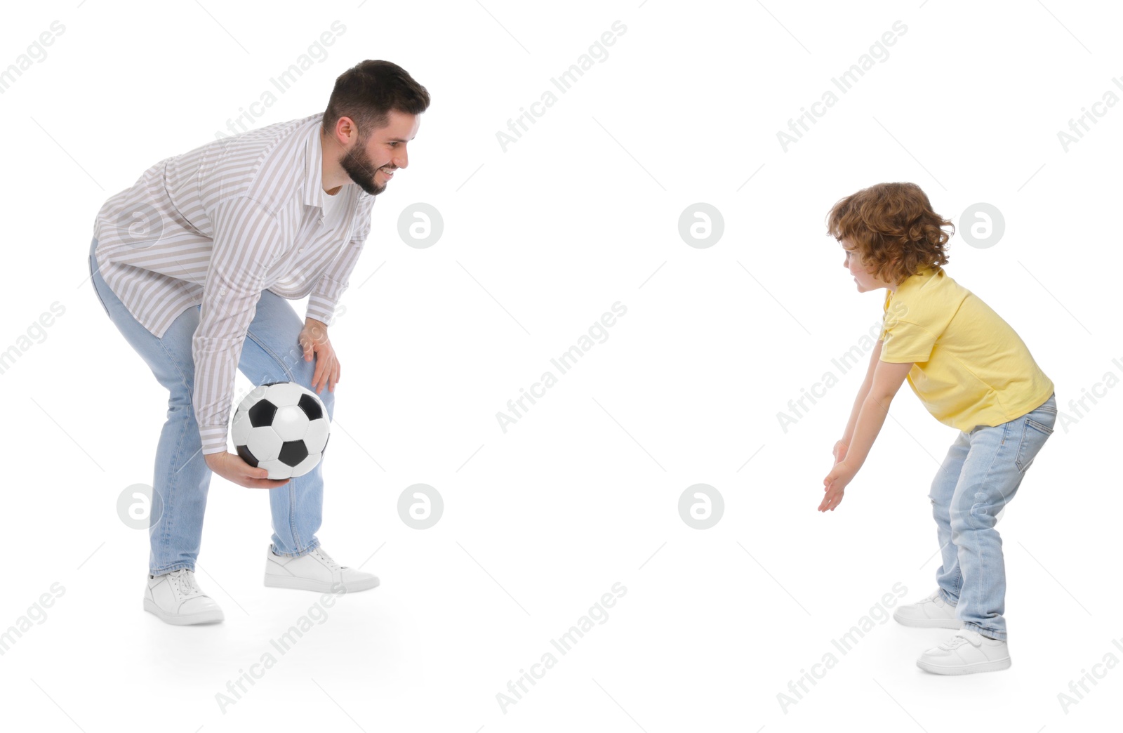 Happy father and his son playing football on white background Photo of Happy father and his son playing football on white background