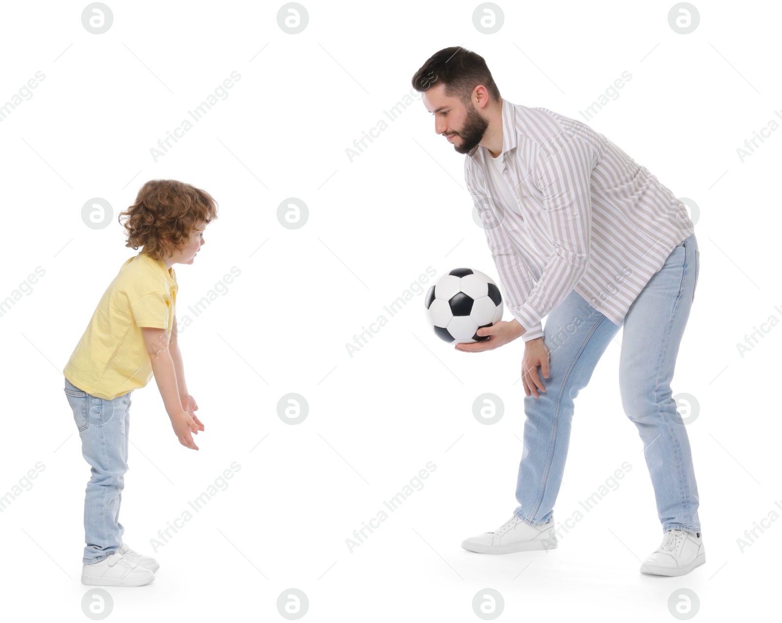 Happy father and his son playing football on white background Photo of Happy father and his son playing football on white background