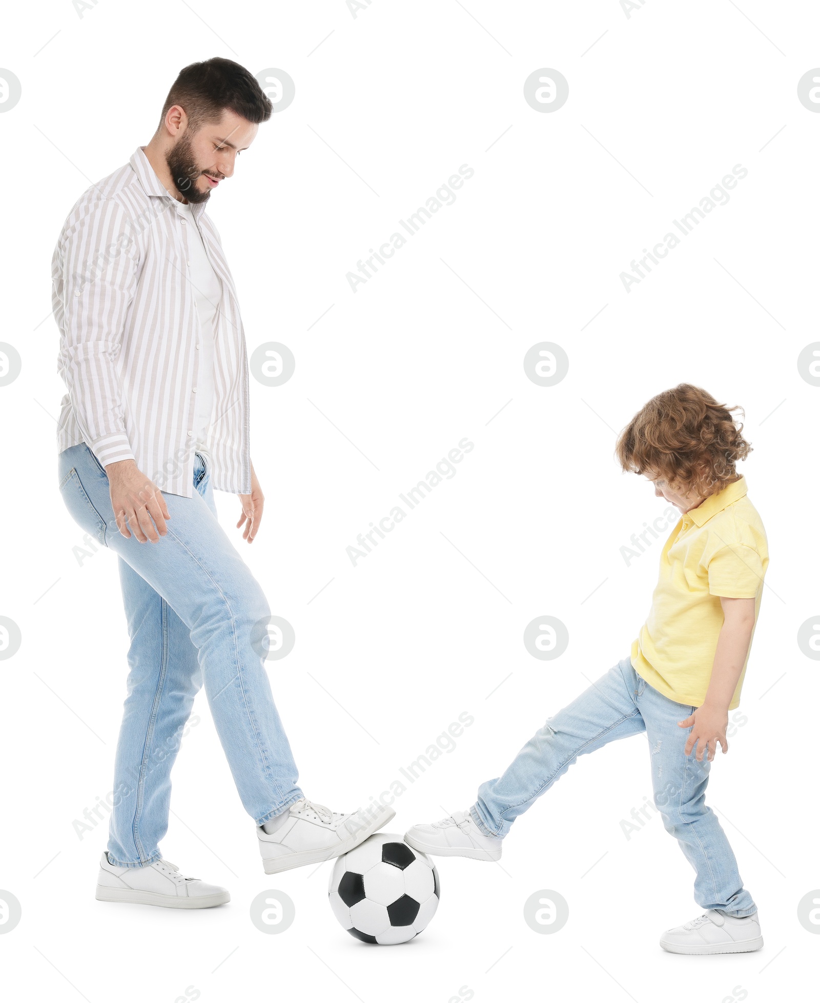 Happy father and his son playing football on white background Photo of Happy father and his son playing football on white background