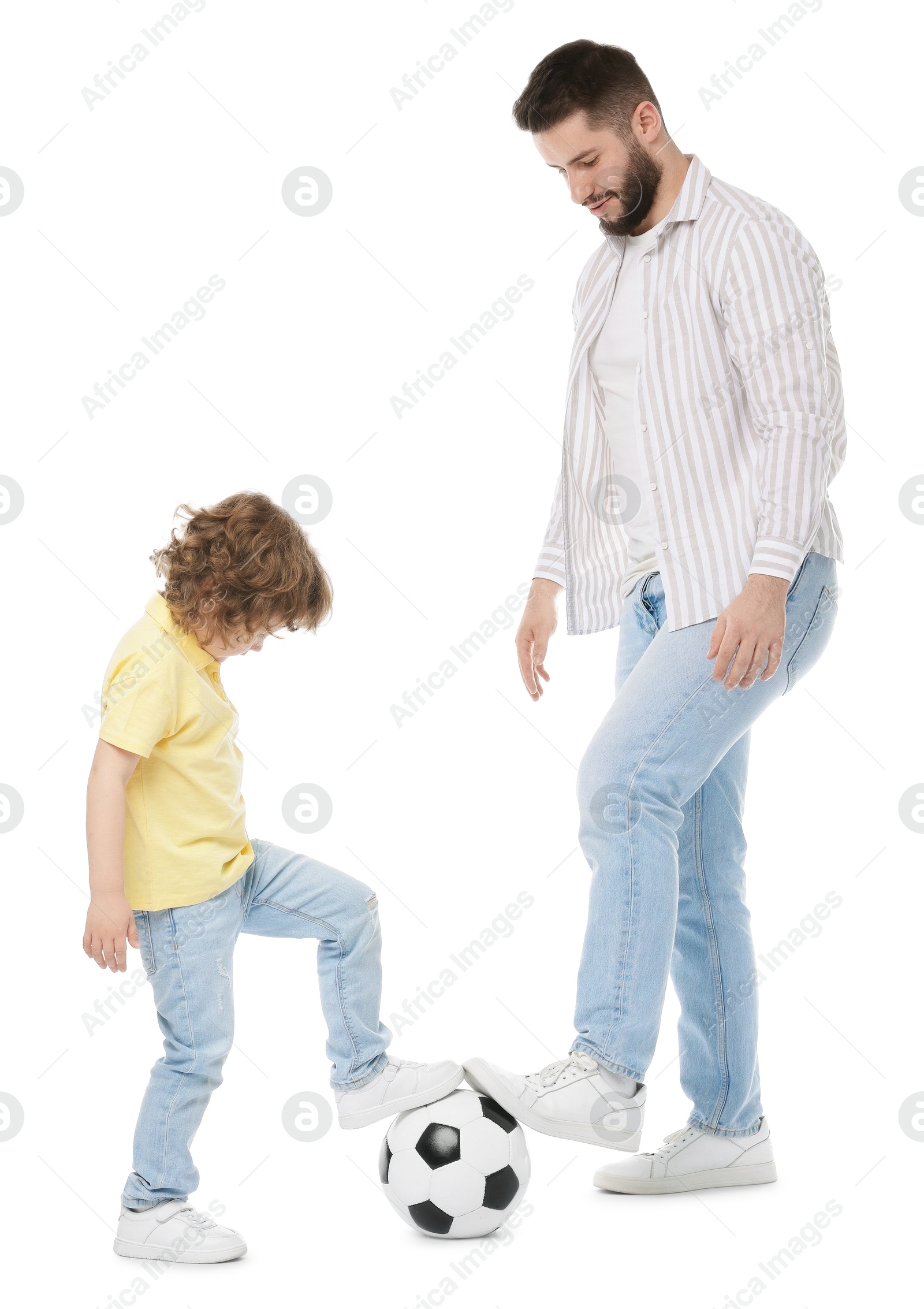 Happy father and his son playing football on white background Photo of Happy father and his son playing football on white background