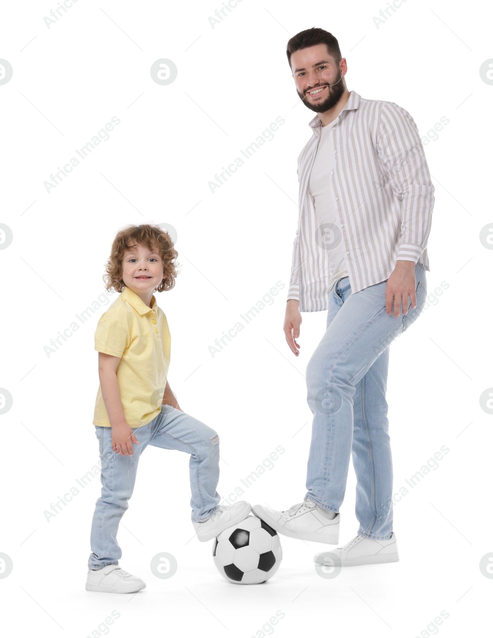 Happy father and his son playing football on white background Photo of Happy father and his son playing football on white background