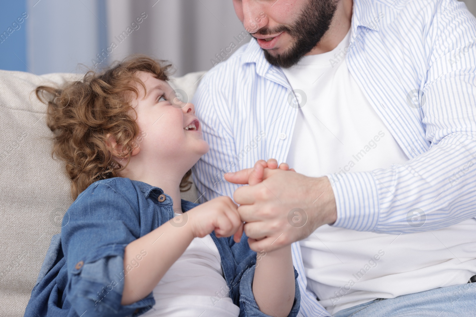 Father and his son spending time together at home, closeup Photo of Father and his son spending time together at home, closeup