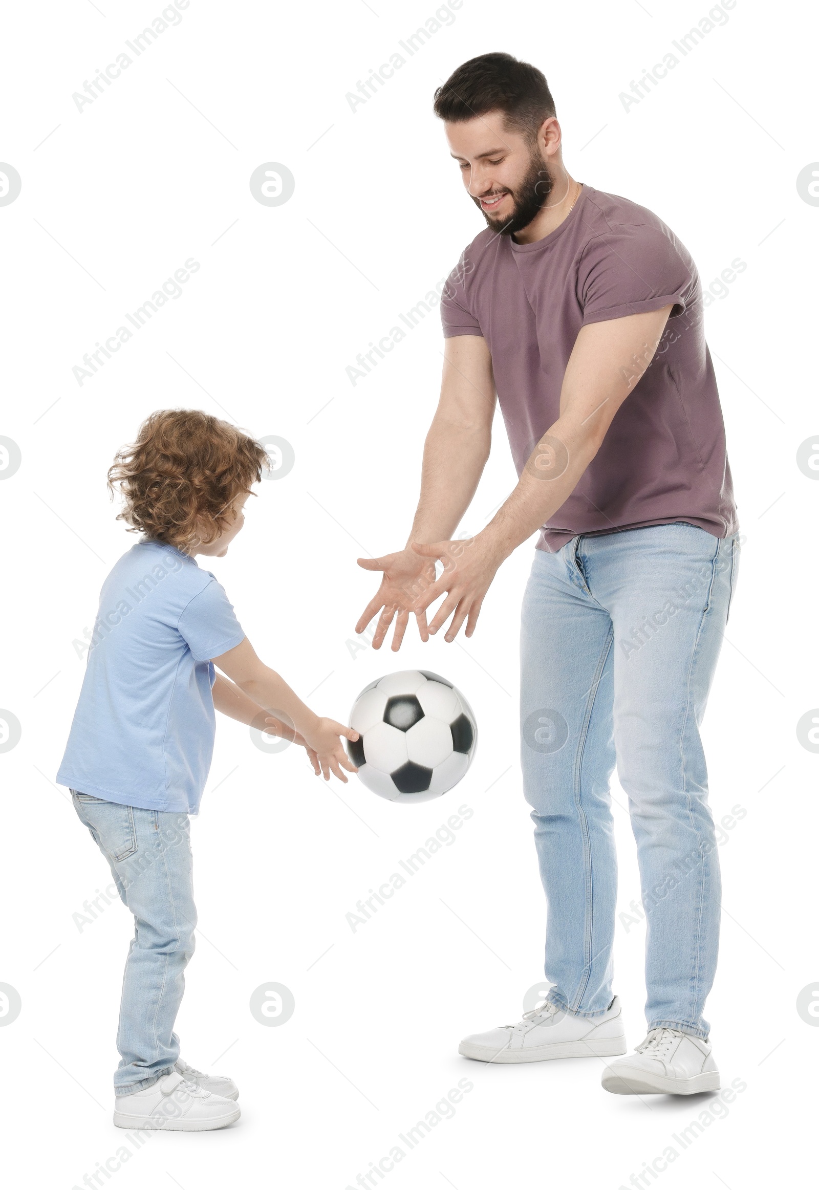 Happy father and his son playing football on white background Photo of Happy father and his son playing football on white background