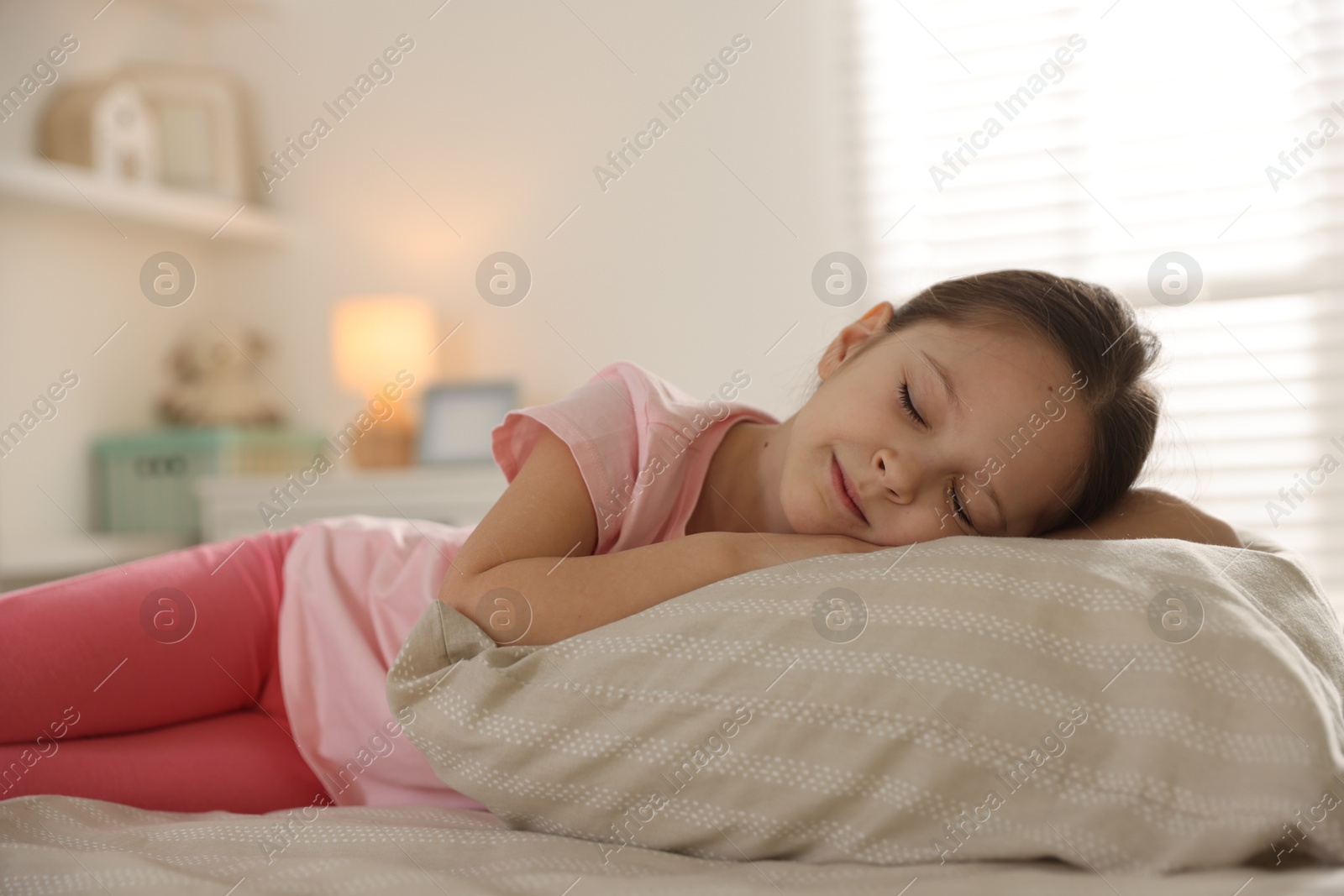 Cute girl sleeping in bed at home. Space for text Photo of Cute girl sleeping in bed at home. Space for text