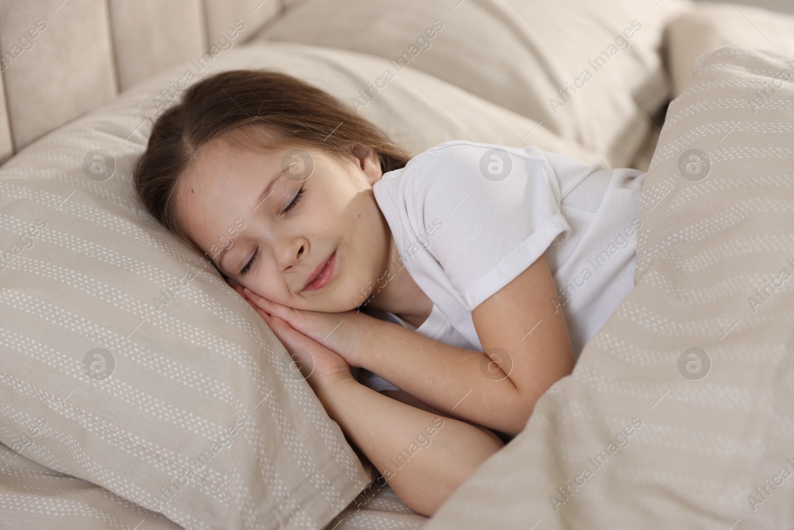 Cute girl sleeping in bed at home Photo of Cute girl sleeping in bed at home