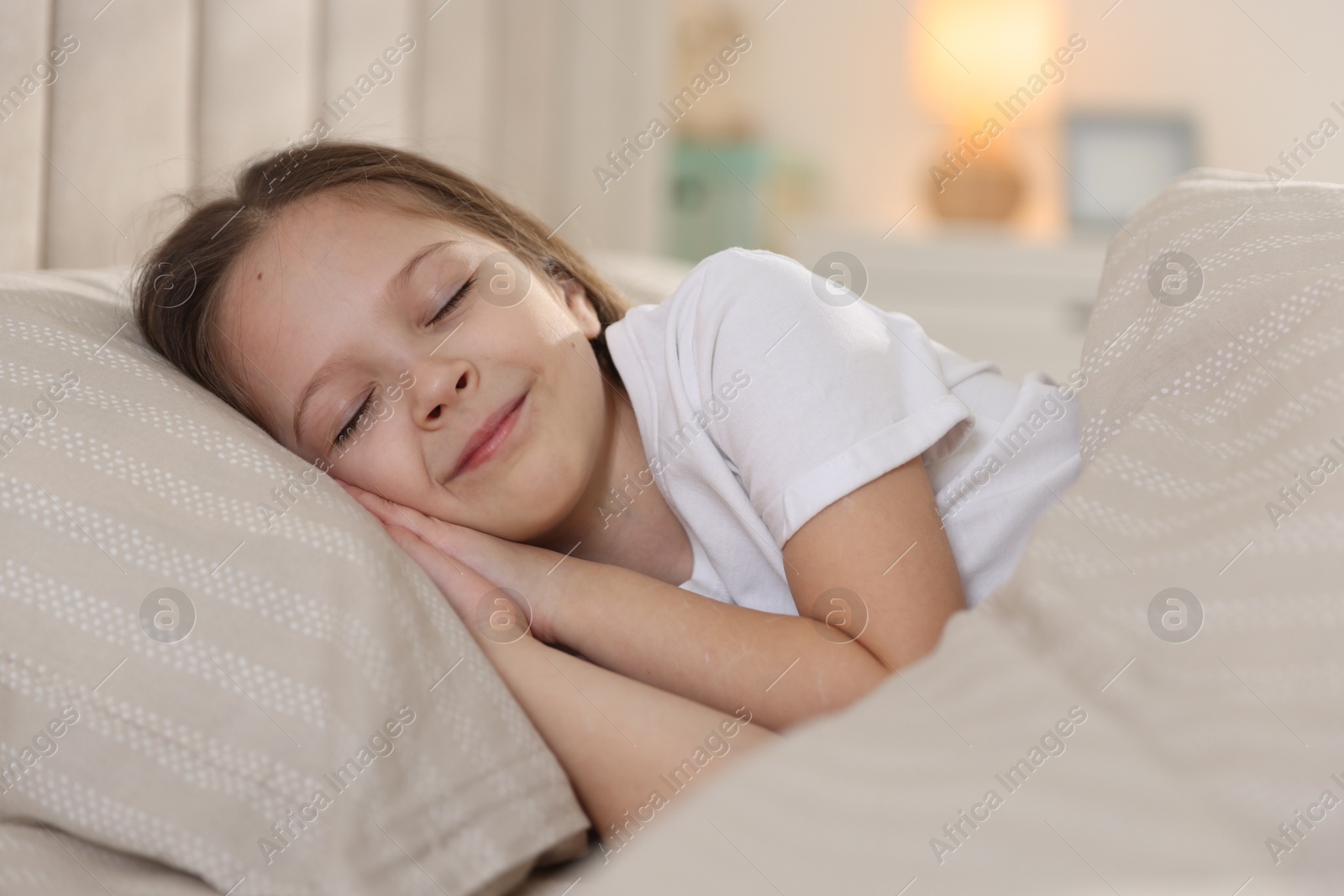 Cute girl sleeping in bed at home Photo of Cute girl sleeping in bed at home