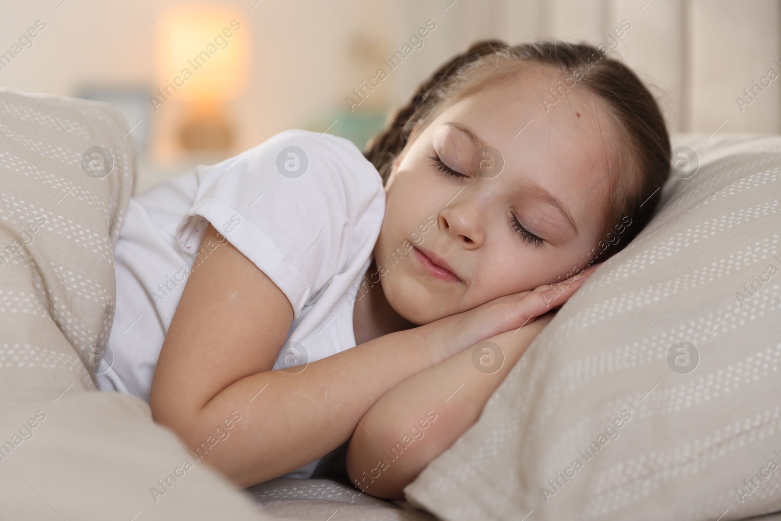 Cute girl sleeping in bed at home Photo of Cute girl sleeping in bed at home