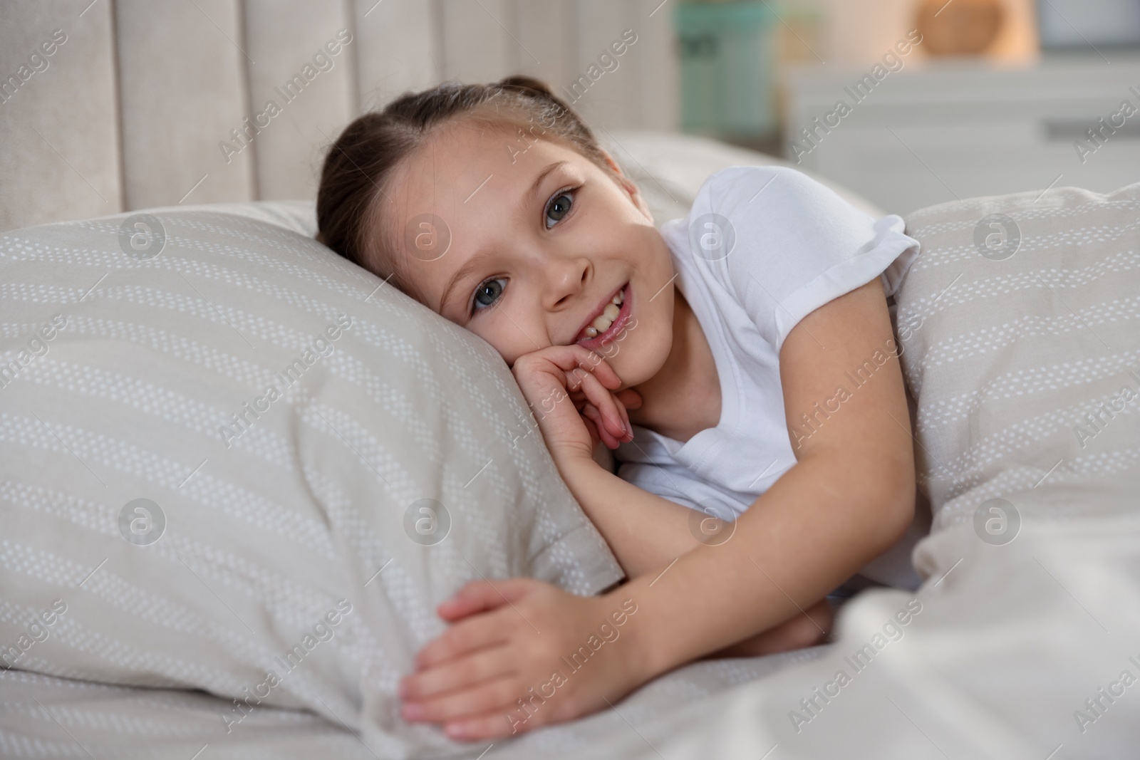 Cute girl lying in bed at home Photo of Cute girl lying in bed at home