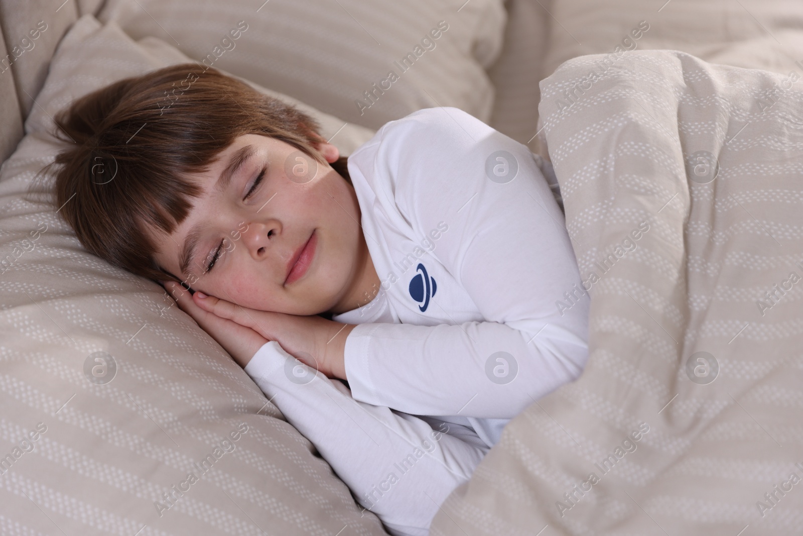 Photo of Cute boy sleeping in bed at home