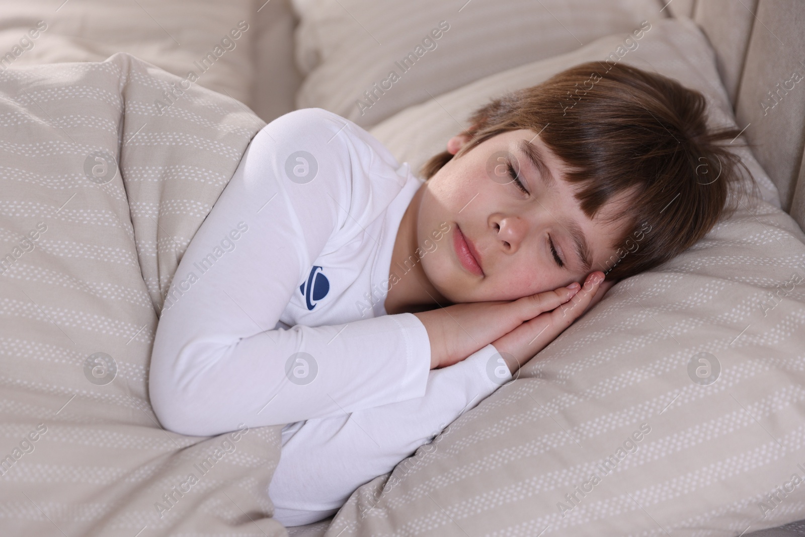 Cute boy sleeping in bed at home Photo of Cute boy sleeping in bed at home