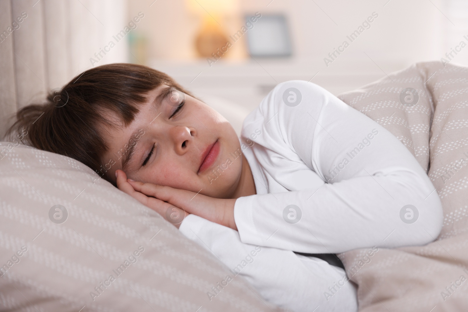 Cute boy sleeping in bed at home Photo of Cute boy sleeping in bed at home