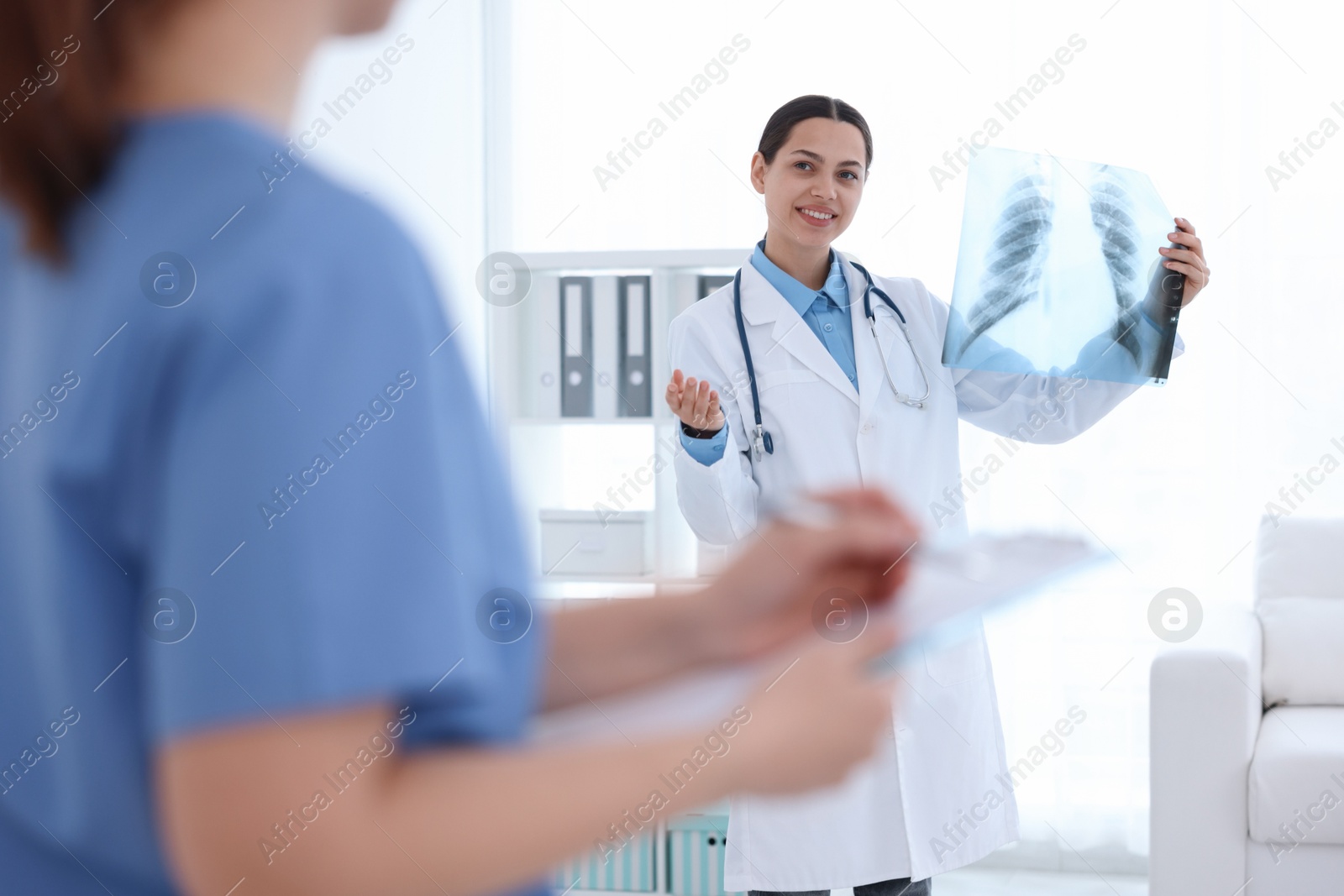 Doctor and nurse examining MRI scan in hospital, selective focus Photo of Doctor and nurse examining MRI scan in hospital, selective focus