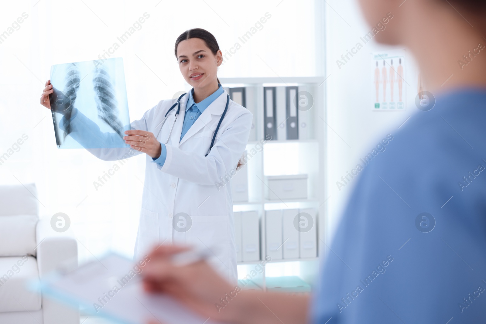 Doctor and nurse examining MRI scan in hospital, selective focus Photo of Doctor and nurse examining MRI scan in hospital, selective focus