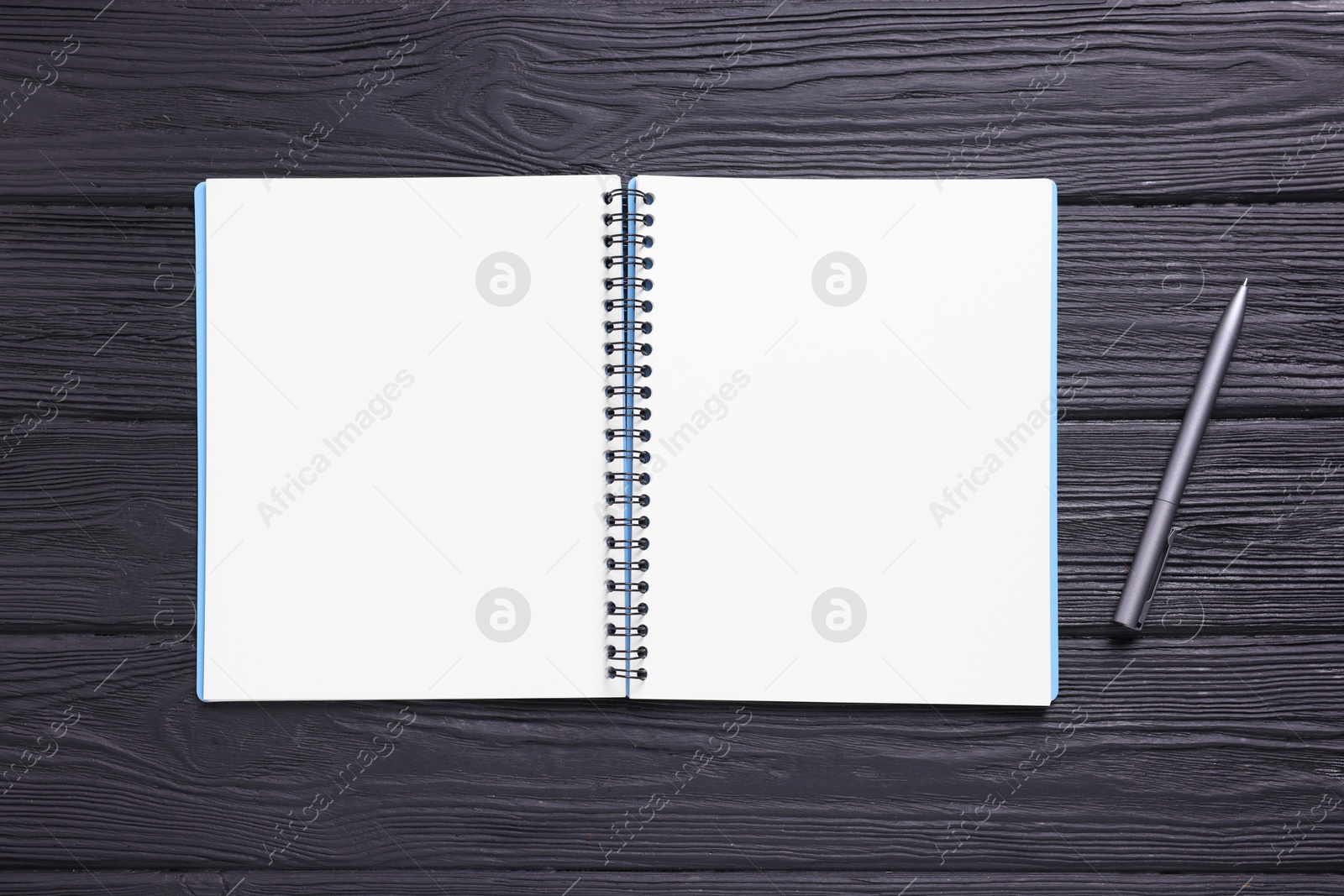 Open blank notebook and pencil on black wooden table, top view Photo of Open blank notebook and pencil on black wooden table, top view