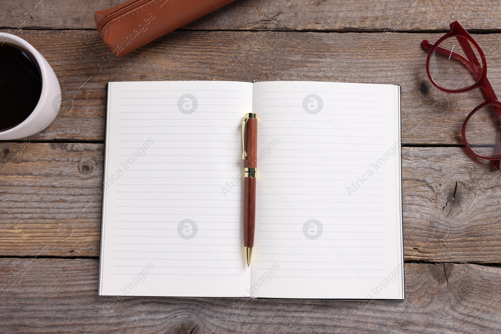 Open blank notebook, coffee, glasses and pen on wooden table, flat lay Photo of Open blank notebook, coffee, glasses and pen on wooden table, flat lay