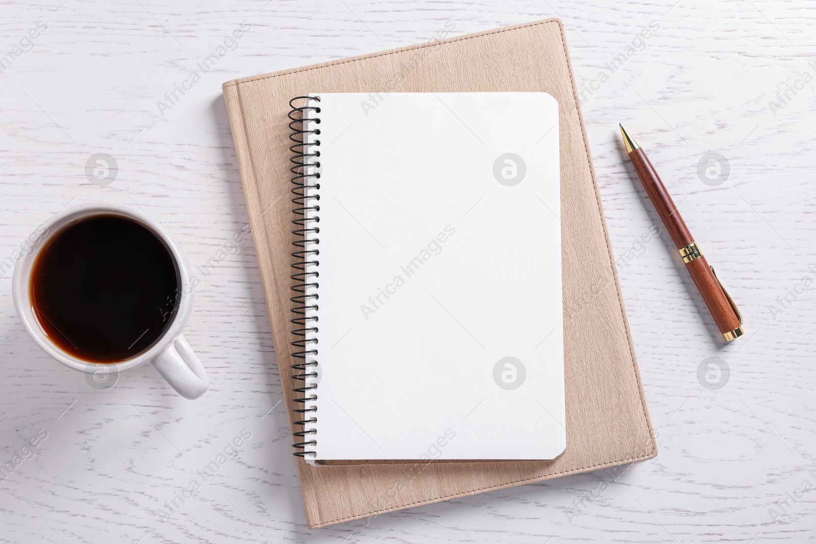 Blank notebooks, coffee and pen on white wooden table, flat lay Photo of Blank notebooks, coffee and pen on white wooden table, flat lay