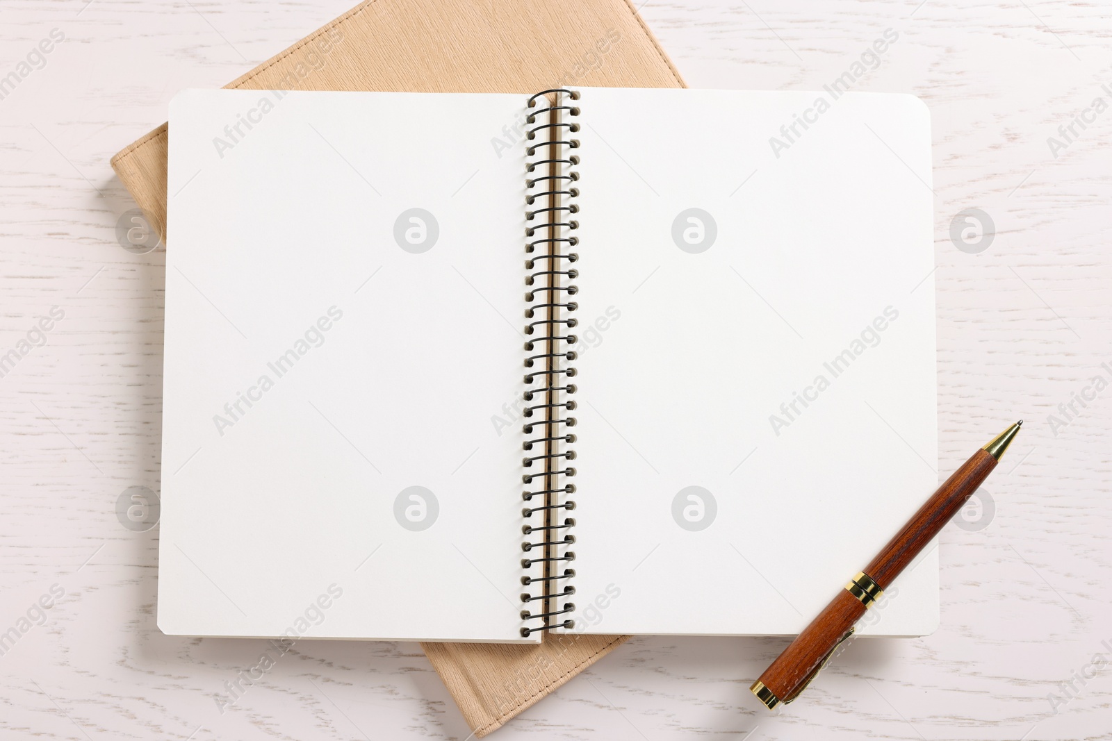 Blank notebooks and pen on white wooden table, top view Photo of Blank notebooks and pen on white wooden table, top view