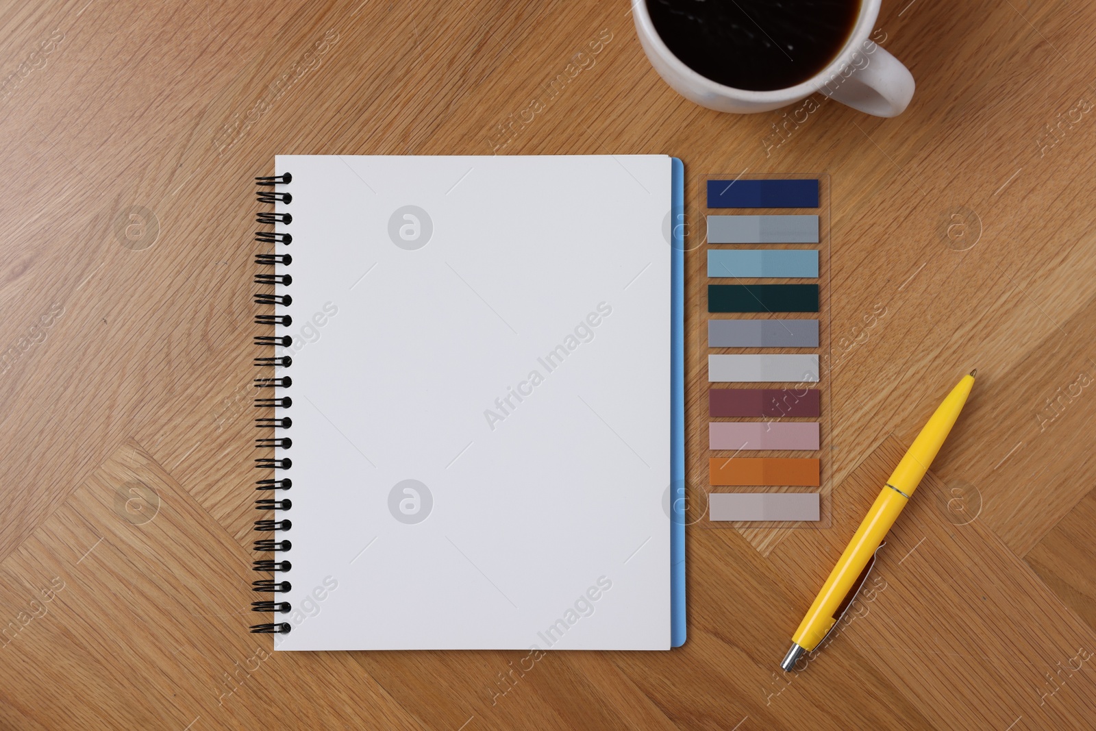 Open blank notebook, coffee, bookmarks and pen on wooden table, flat lay Photo of Open blank notebook, coffee, bookmarks and pen on wooden table, flat lay