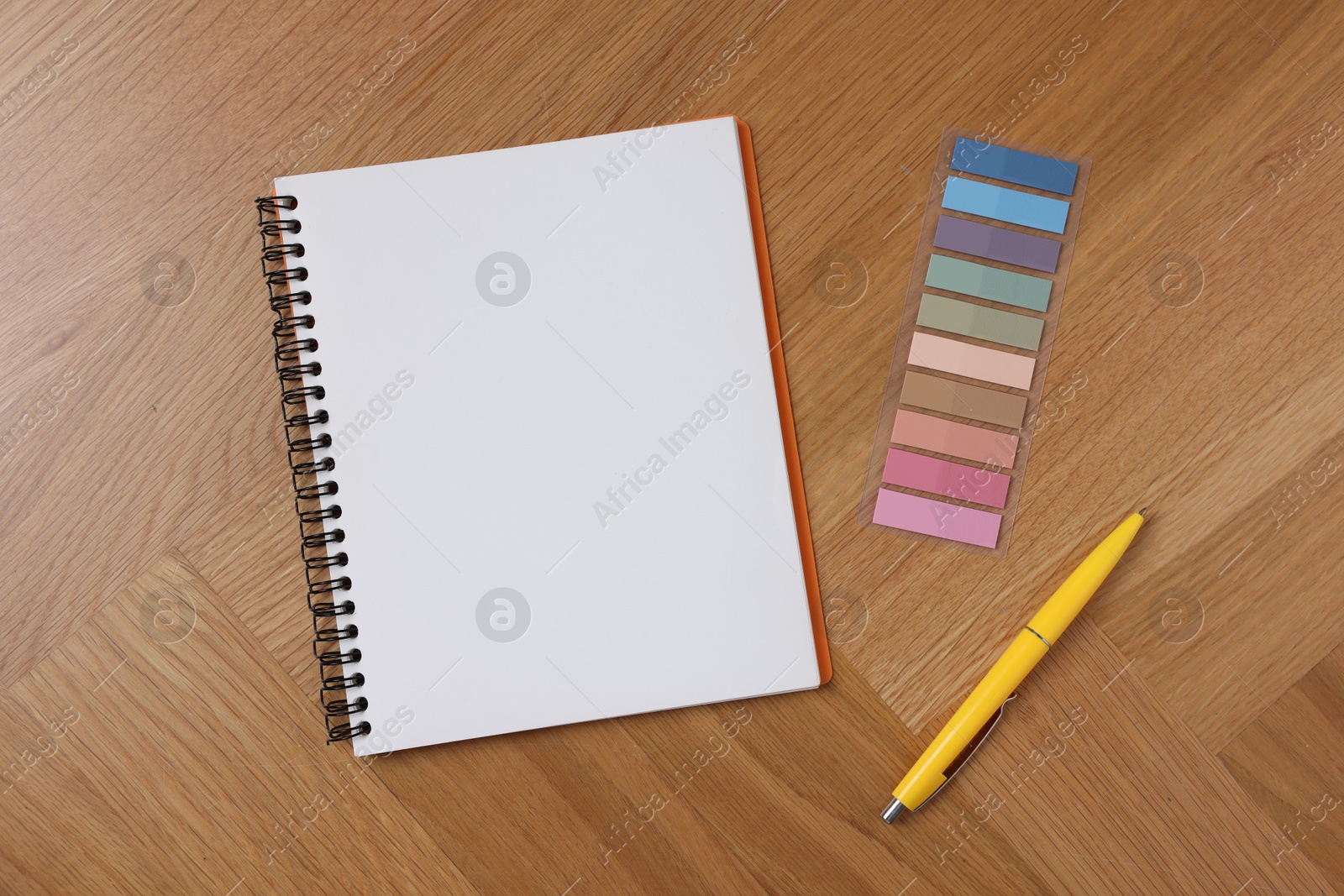 Open blank notebook, bookmarks and pen on wooden table, flat lay Photo of Open blank notebook, bookmarks and pen on wooden table, flat lay