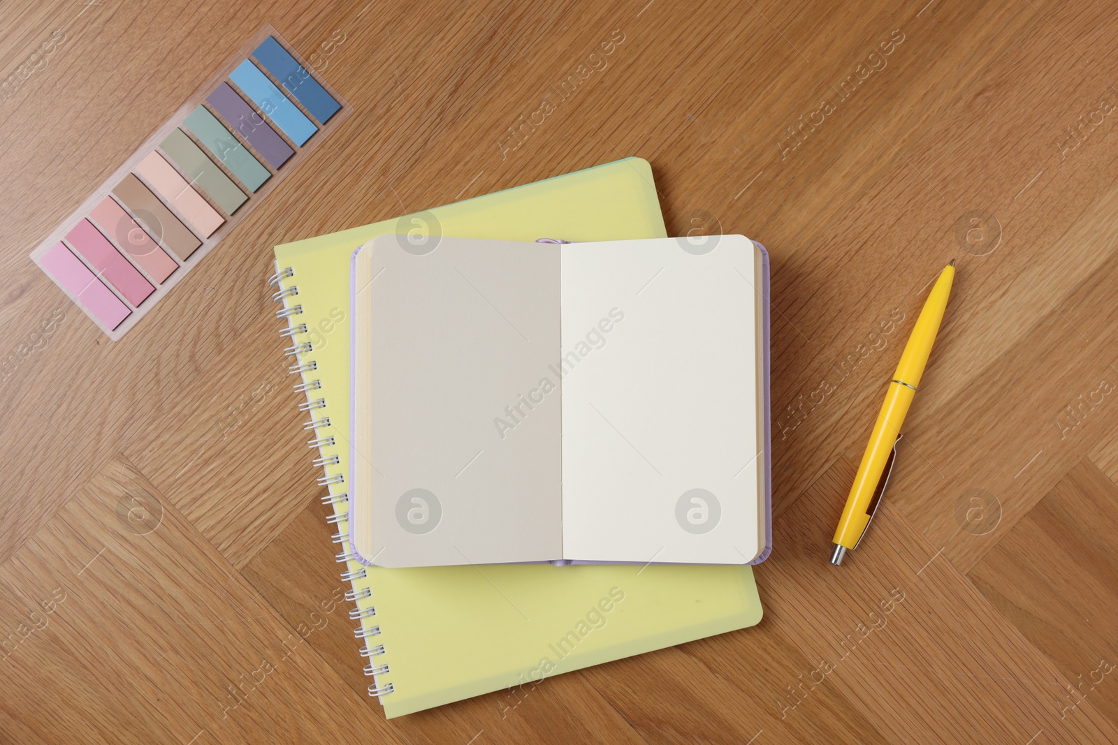 Blank notebooks, bookmarks and pen on wooden table, flat lay Photo of Blank notebooks, bookmarks and pen on wooden table, flat lay