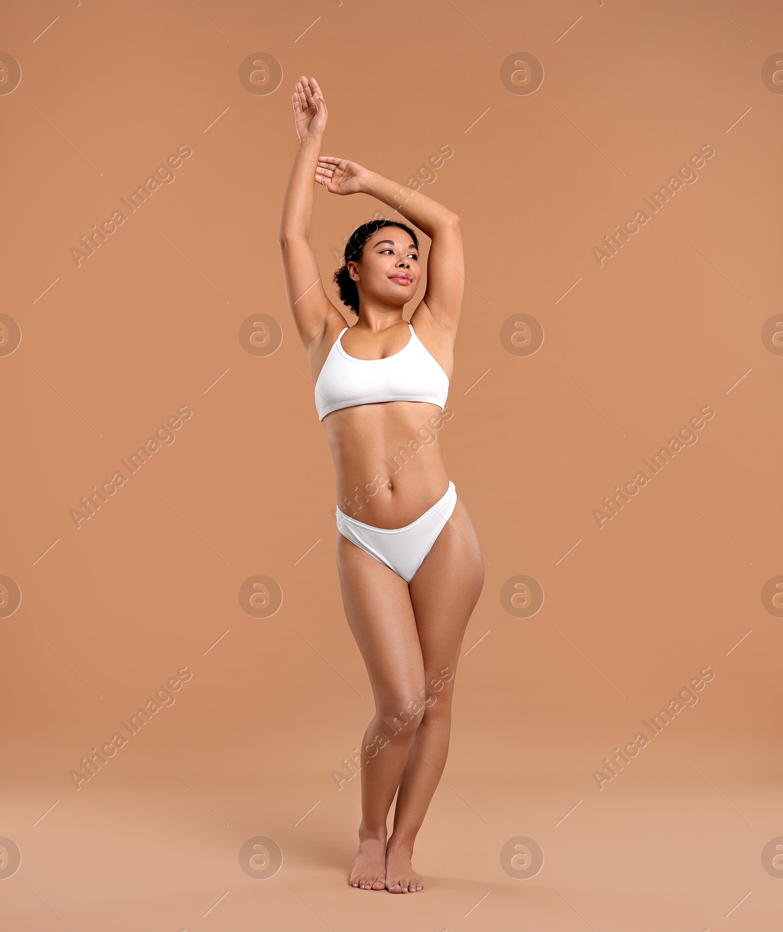 Photo of Woman in white underwear with smooth skin after epilation procedure on beige background