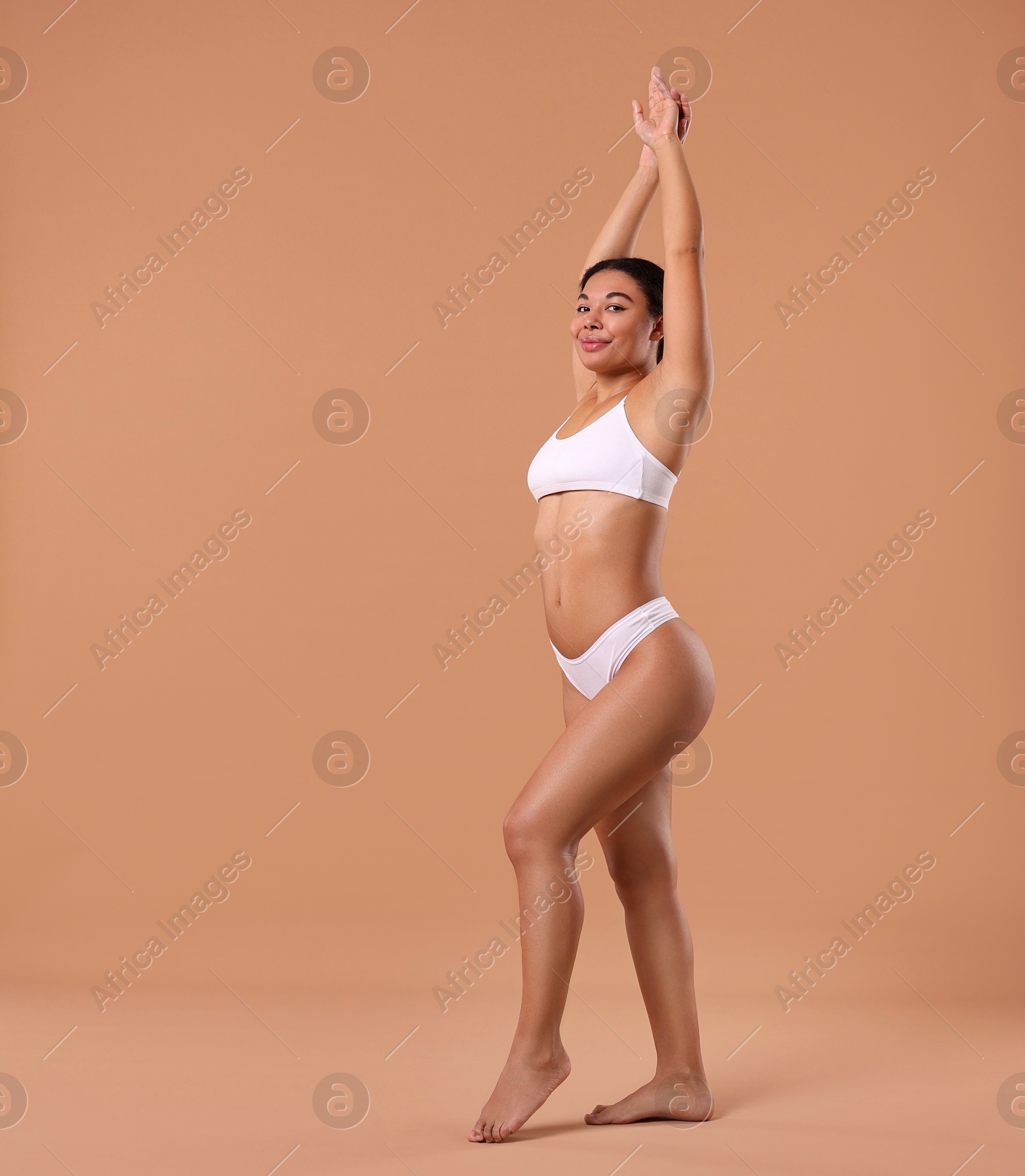 Woman in underwear with smooth skin after epilation procedure on beige background, space for text Photo of Woman in underwear with smooth skin after epilation procedure on beige background, space for text