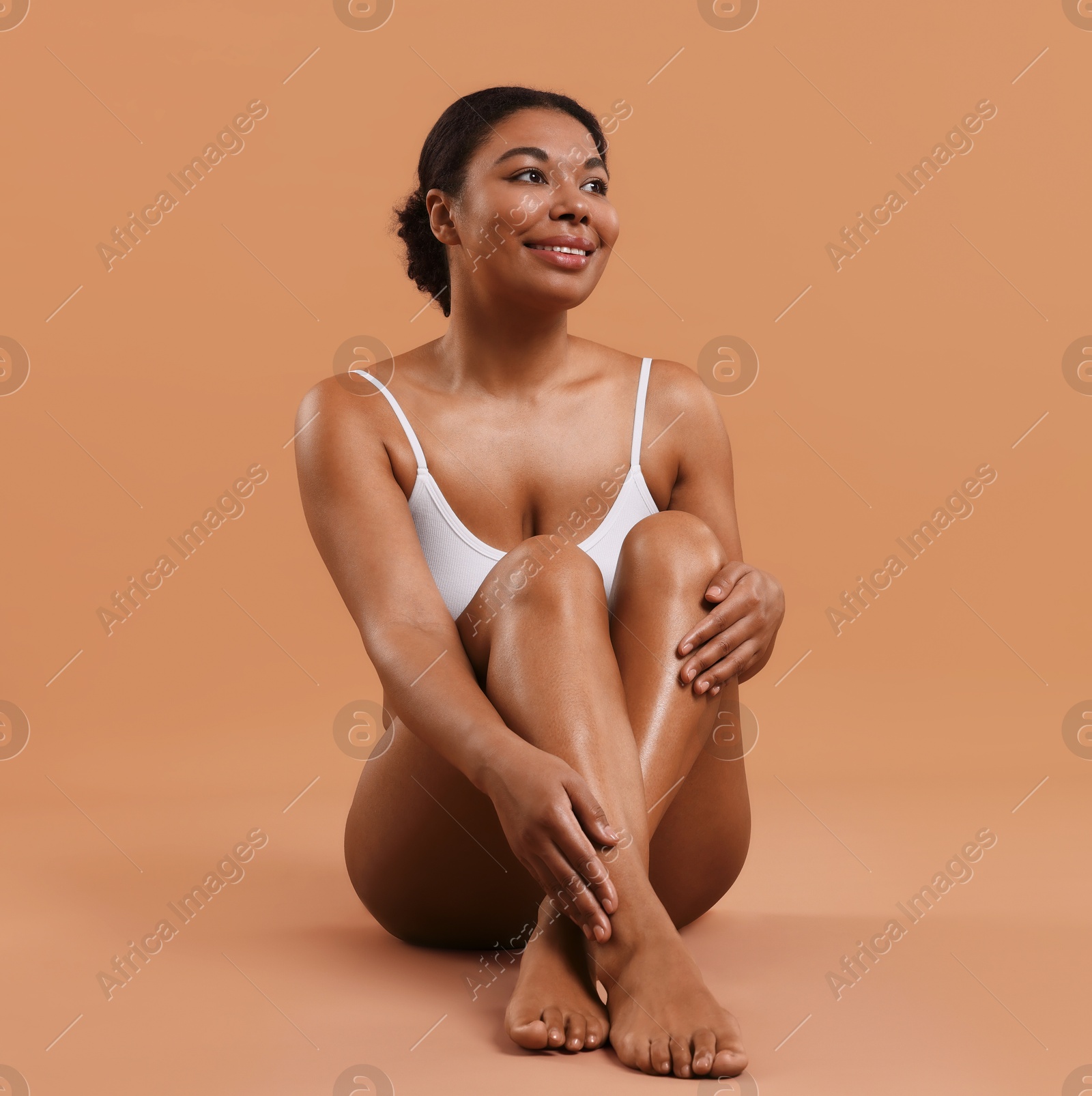 Woman in underwear with smooth skin after epilation procedure on beige background, space for text Photo of Woman in underwear with smooth skin after epilation procedure on beige background, space for text