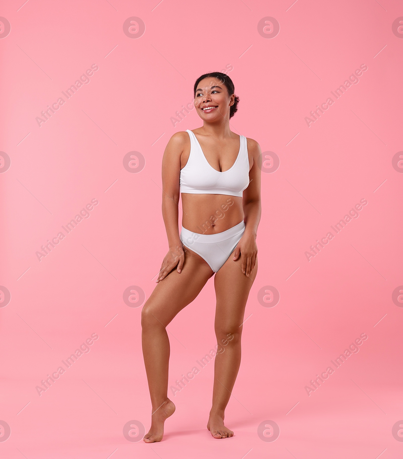 Photo of Woman in underwear with smooth skin after epilation procedure on pink background, space for text