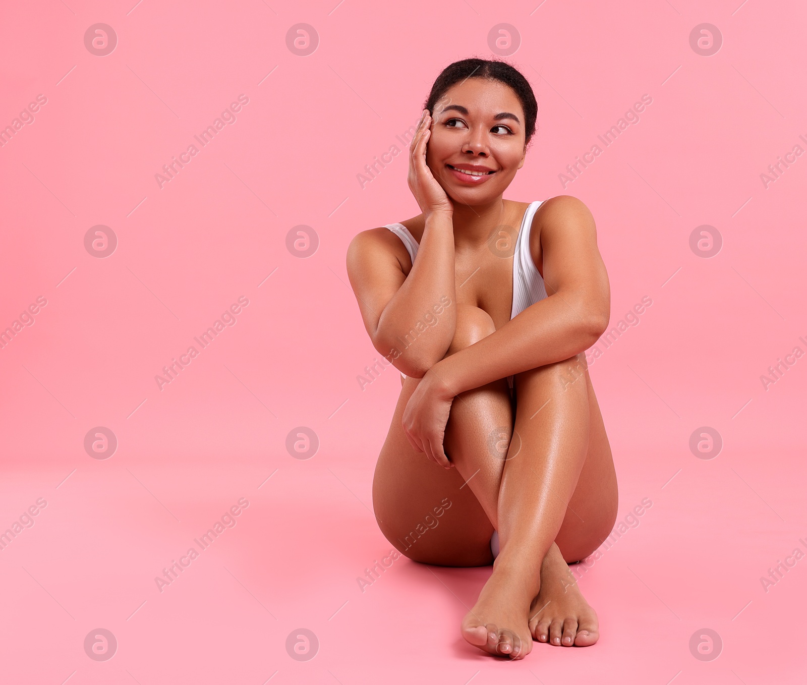 Woman in underwear with smooth skin after epilation procedure on pink background, space for text Photo of Woman in underwear with smooth skin after epilation procedure on pink background, space for text