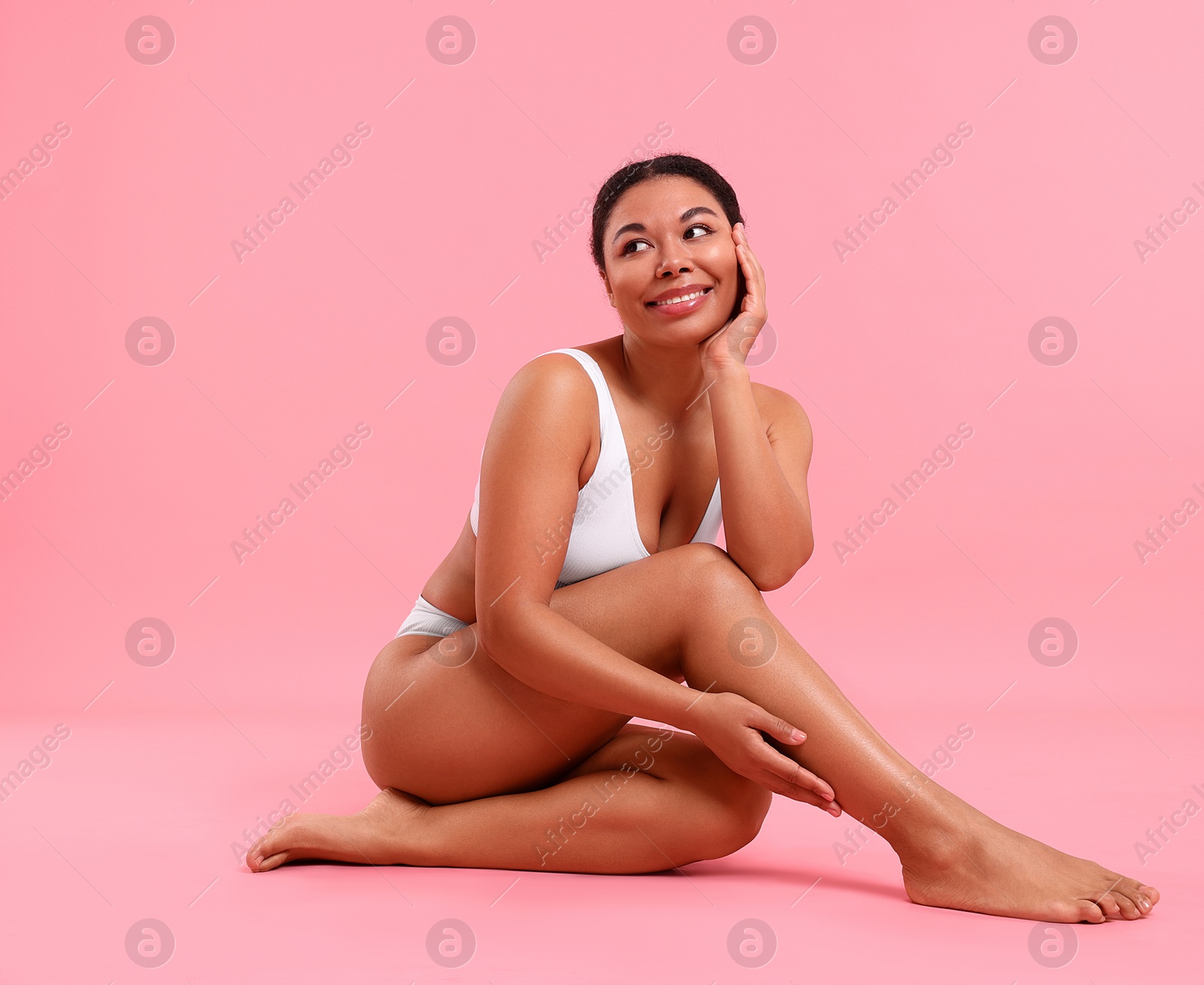 Woman in underwear with smooth skin after epilation procedure on pink background, space for text Photo of Woman in underwear with smooth skin after epilation procedure on pink background, space for text