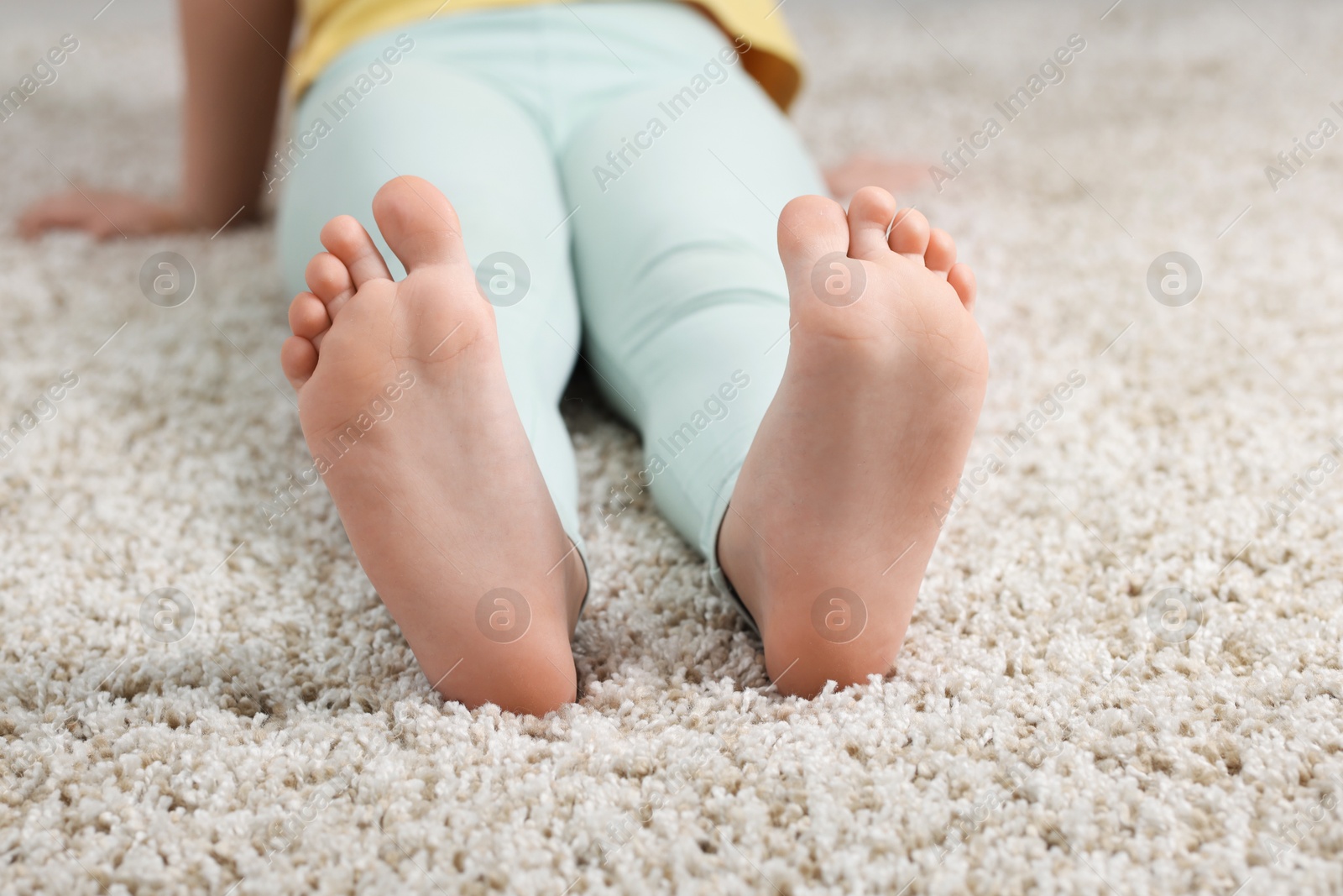 Girl on soft carpet at home, closeup Photo of Girl on soft carpet at home, closeup