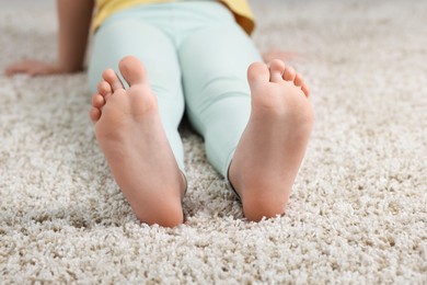 Photo of Girl on soft carpet at home, closeup