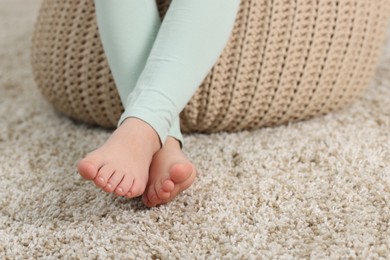 Photo of Girl on soft carpet at home, closeup