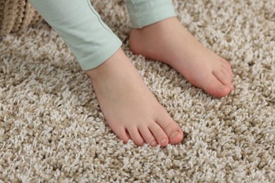 Photo of Girl on soft carpet at home, closeup