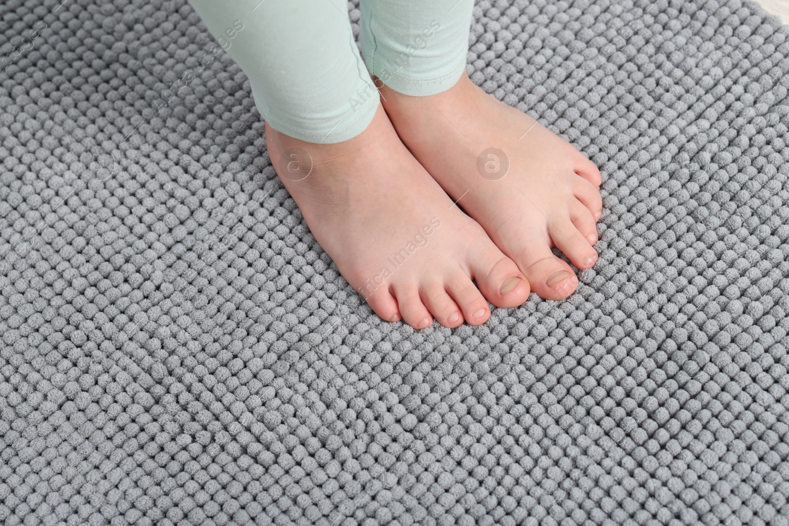 Girl on soft carpet at home, above view Photo of Girl on soft carpet at home, above view