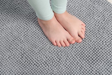 Photo of Girl on soft carpet at home, above view