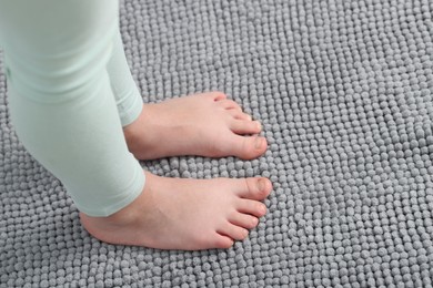 Photo of Girl on soft carpet at home, above view