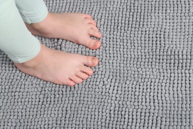 Photo of Girl on soft carpet at home, above view. Space for text
