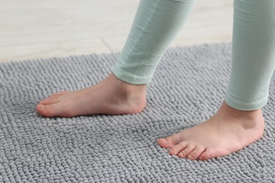 Photo of Girl on soft carpet at home, closeup