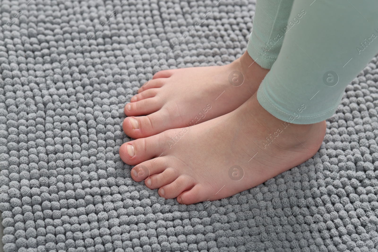 Girl on soft carpet at home, above view Photo of Girl on soft carpet at home, above view