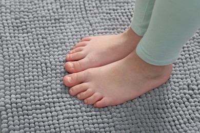 Photo of Girl on soft carpet at home, above view