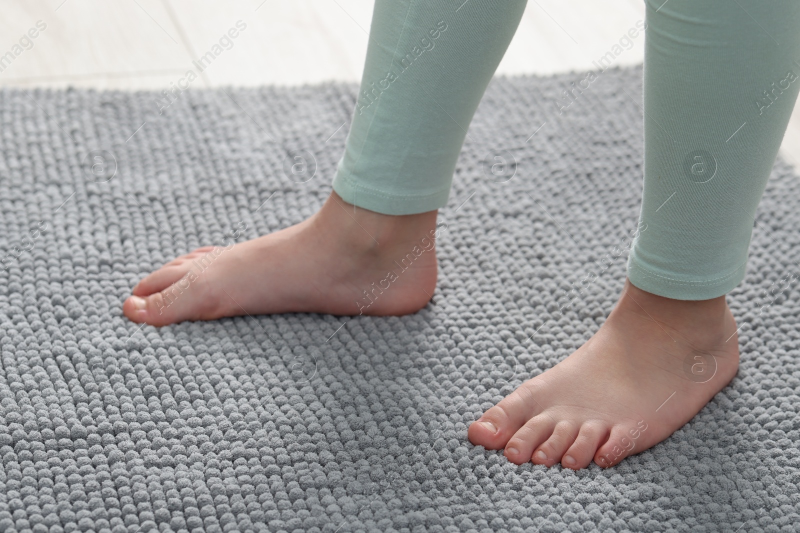 Girl on soft carpet at home, closeup Photo of Girl on soft carpet at home, closeup