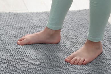 Photo of Girl on soft carpet at home, closeup